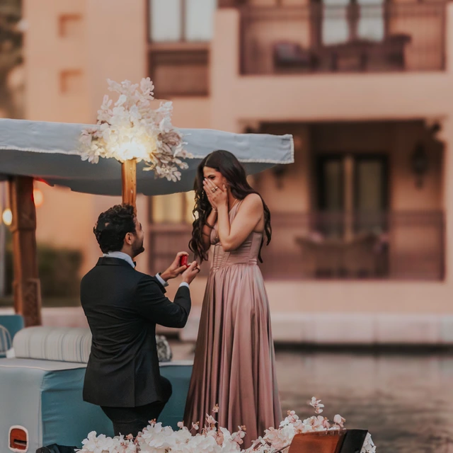 Dubai photoshoot A couple looking at eachother being photographed during a Dubai photoshoot near Burj Al Arab at shimmers