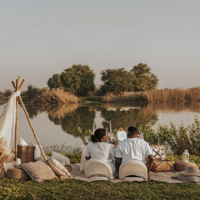 Dubai picnic proposal Couple staring at the nature whilst sitting at a picnic setup in Dubai