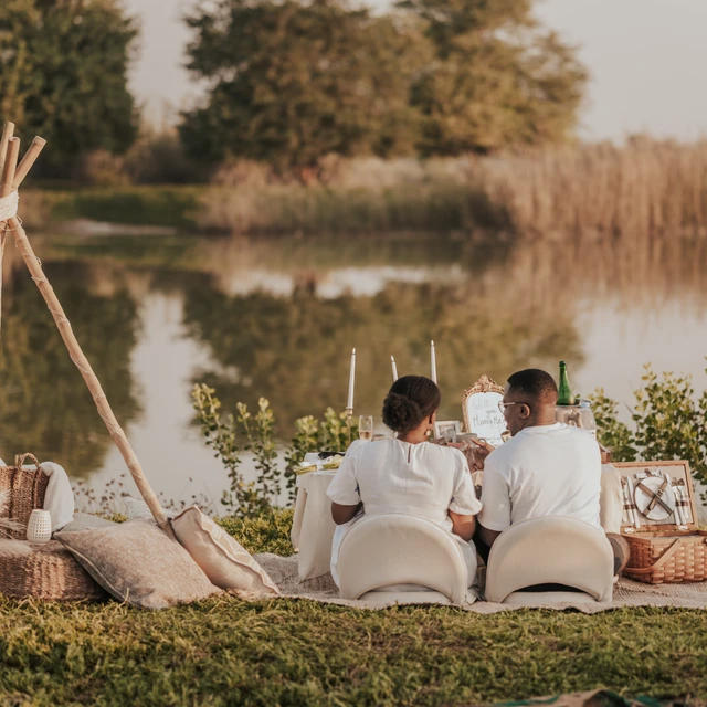 Dubai picnic proposal Couple sitting by their Dubai picnic looking over the water after a succesfull proposal