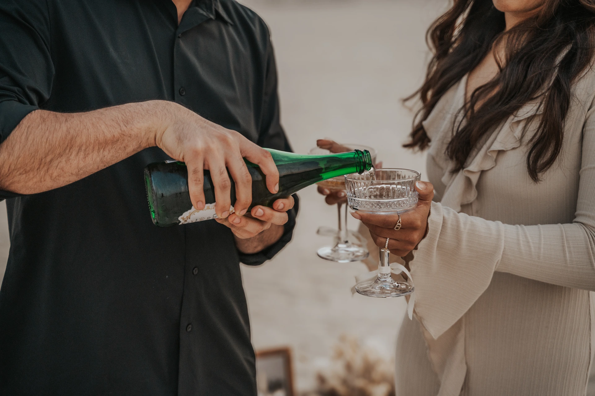 A couple toasting with bubbles after their proposal in Dubai