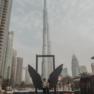 Couple being photographed while doing their proposal at the wings of mexico in dubai.