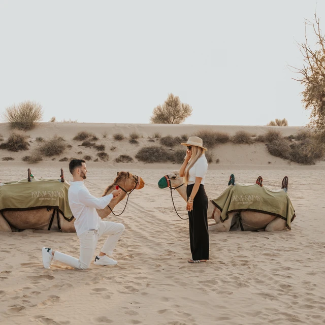 Dubai Proposal Photographer Image of couple that just proposed in the dunes in Dubai captured by a Dubai photographer.