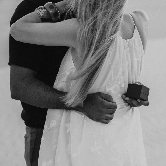 Dubai Proposal Photographer Image of couple that just proposed in the dunes in Dubai captured by a Dubai photographer.