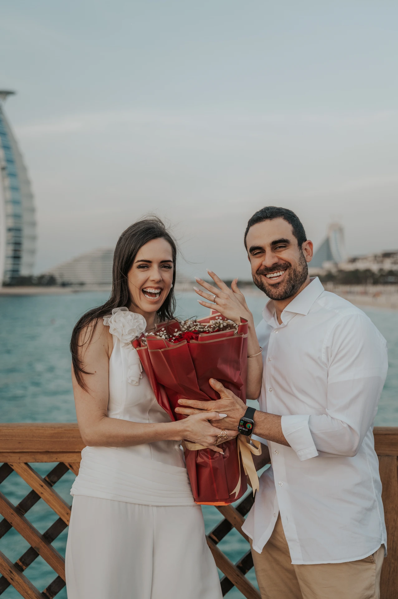 Image of couple that just proposed in the dunes in Dubai captured by a Dubai photographer.