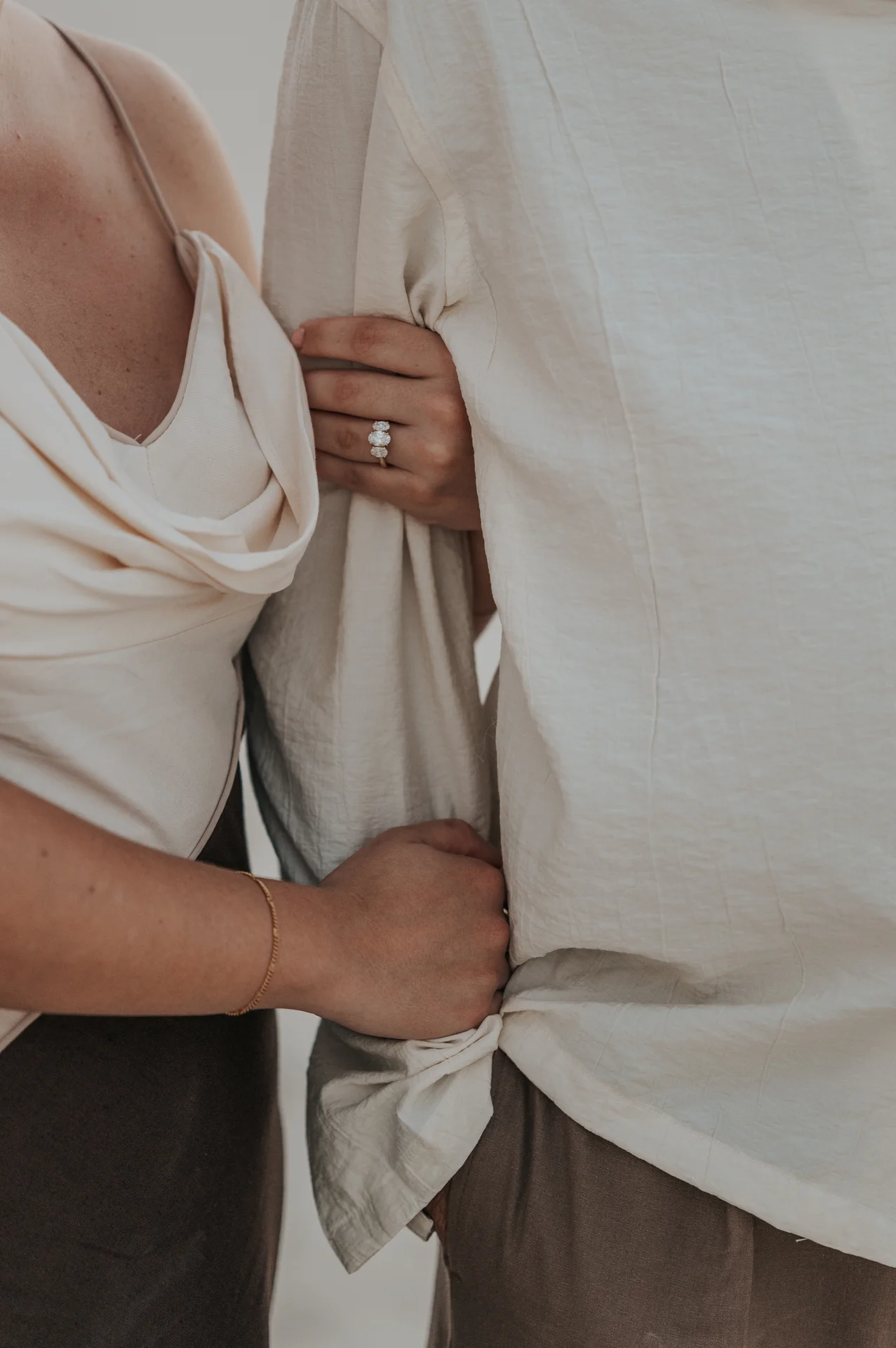 Dubai Proposal Ring Close-Up A woman’s engagement ring rests against her partner’s white shirt in a close-up Dubai proposal photography portrait.