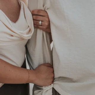 Couple holding hands after a proposal in Dubai, where the photographer captured the diamond ring beautifully.