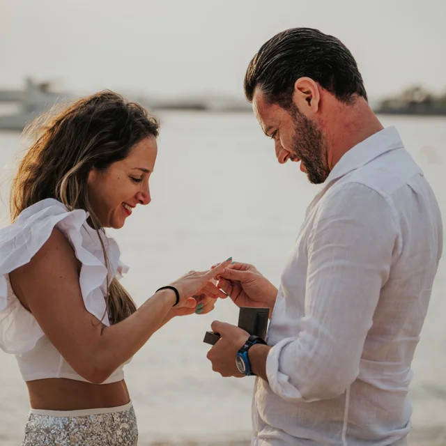 A couple looking at eachother being photographed by a Dubai Photographer in the desert. Dubai Photographer