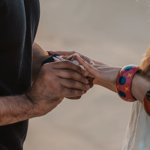 Dubai Proposal Photographer Image of couple that just proposed in the dunes in Dubai captured by a Dubai photographer.