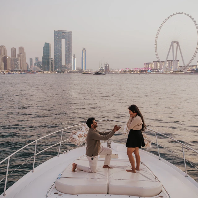 Dubai Yacht Proposal A proposal on a yacht in Dubai with Dubai Marina and Blue Waters in the background.