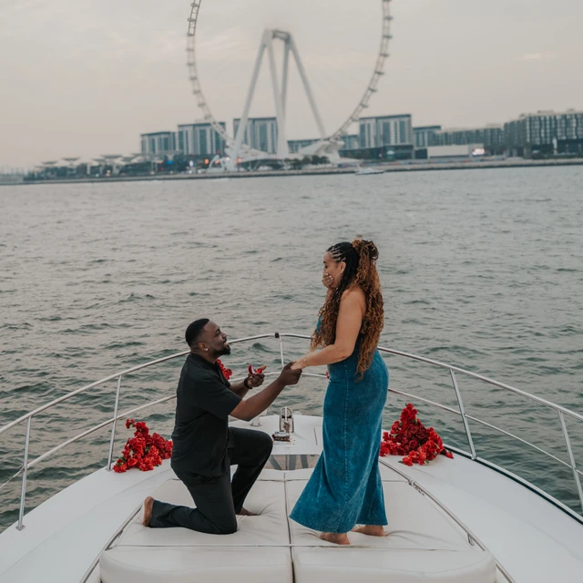Dubai Yacht Proposal A proposal on a yacht in Dubai with Dubai Marina and Blue Waters in the background.