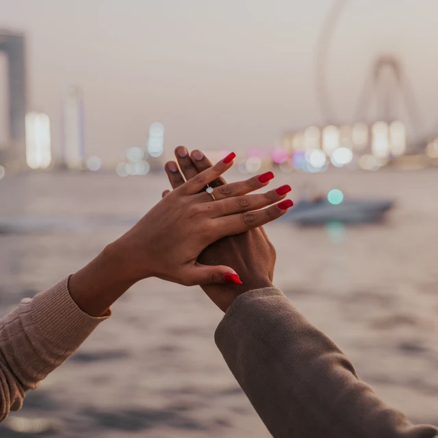 Dubai Yacht Proposal A proposal on a yacht in Dubai with Dubai Marina and Blue Waters in the background.