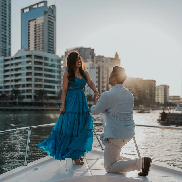 Dubai Yacht Proposal A proposal on a yacht in Dubai with Dubai Marina and Blue Waters in the background.
