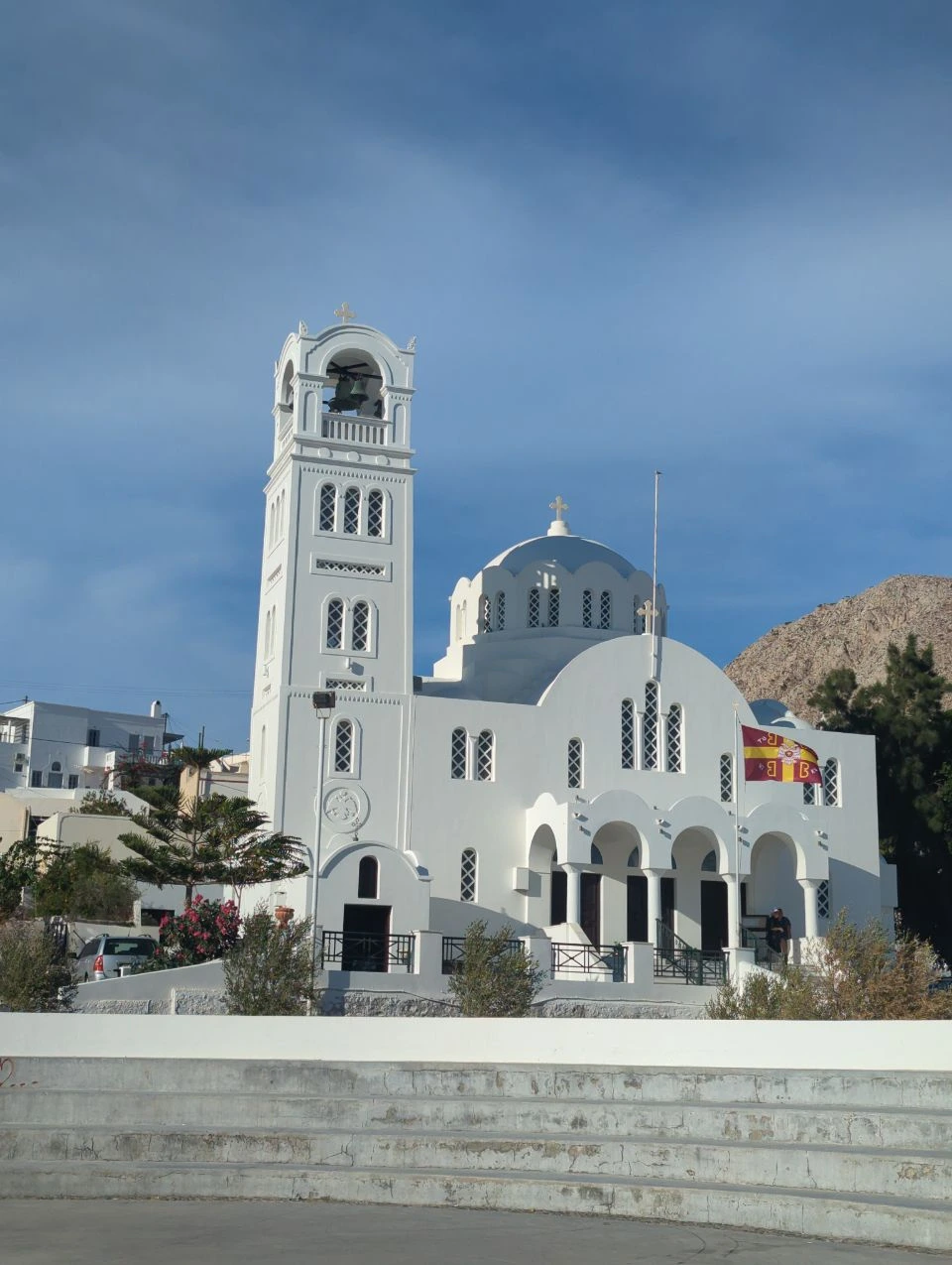 Emporio church and square | Santorini village highlights White church with a bell tower and pale blue dome in Emporio, Santorini