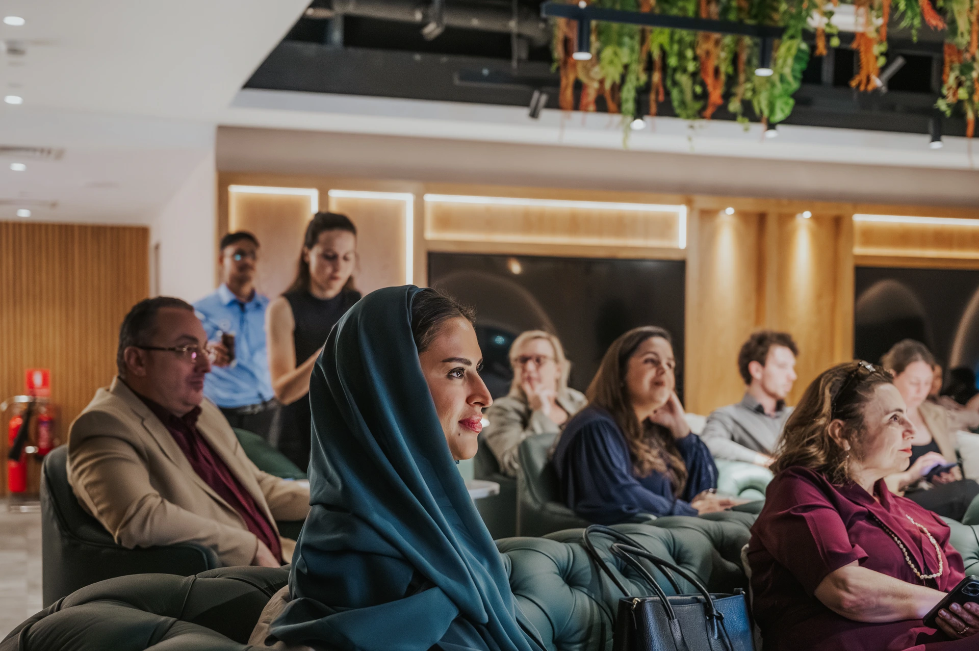 Dubai event photographer A lady being captured by a photographer whilst she is listing to a speaker at an event in Dubai