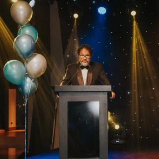 Photography of a business event in Dubai with a keynote speaker at center stage