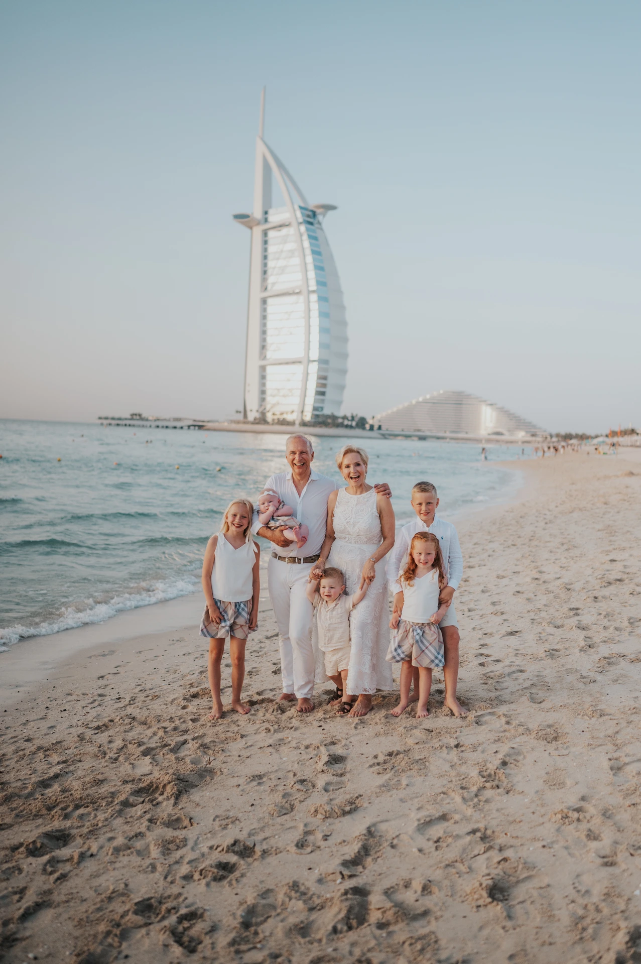 Large family portrait at Dubai beach with Burj Al Arab in background