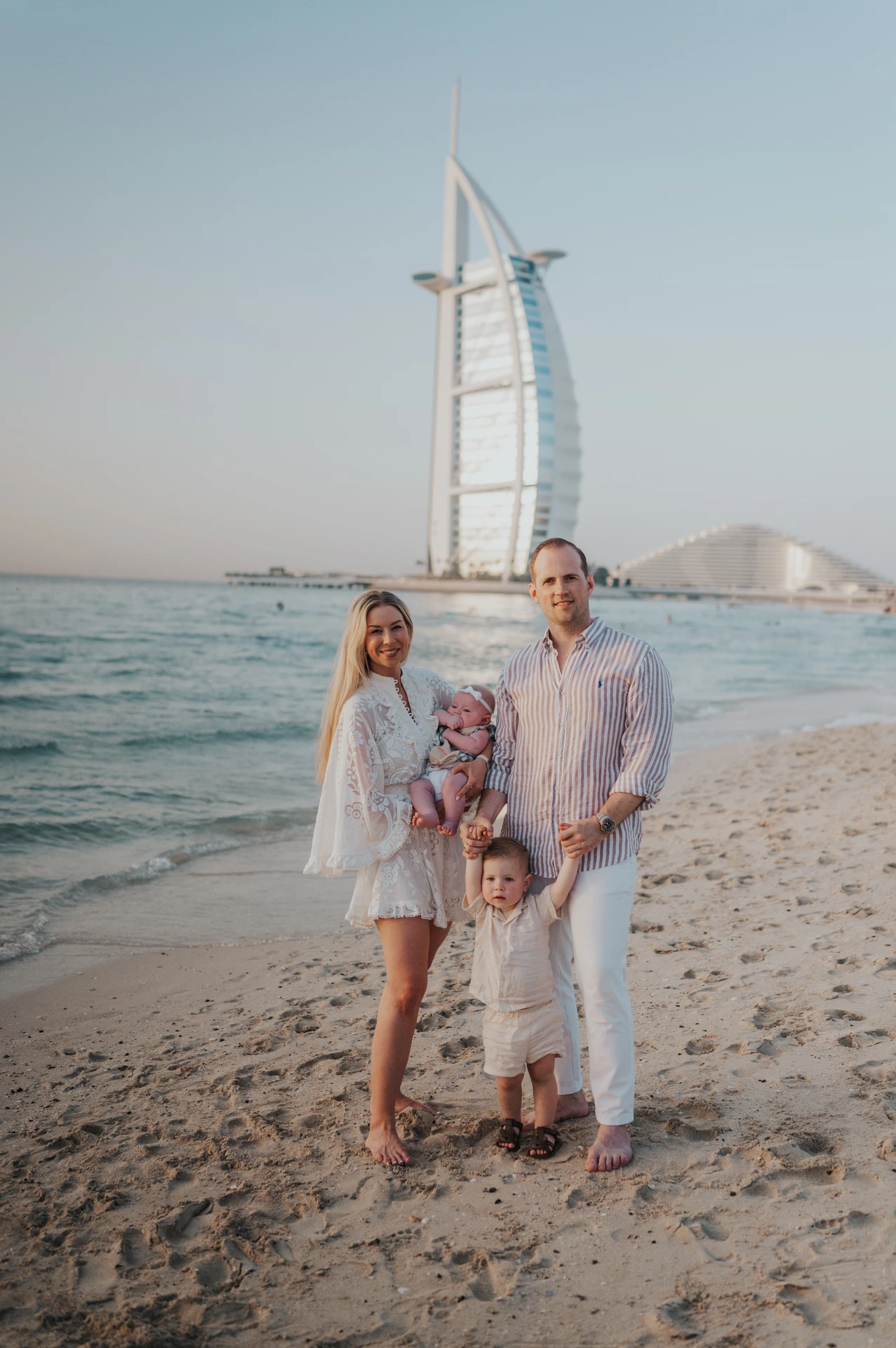Small family portrait at Dubai beach with Burj Al Arab in background