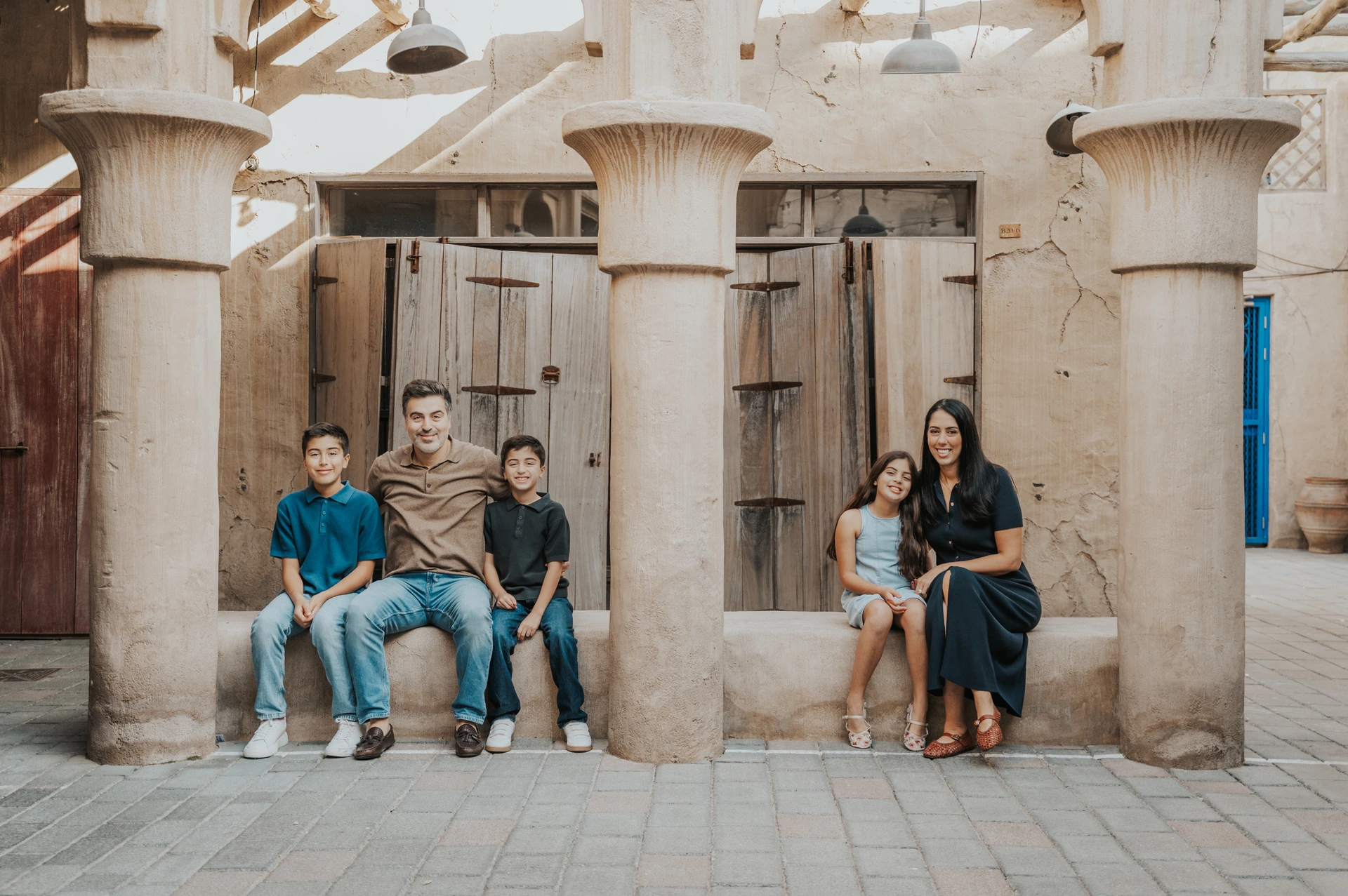 Family portrait in Old Dubai cultural area with traditional architecture