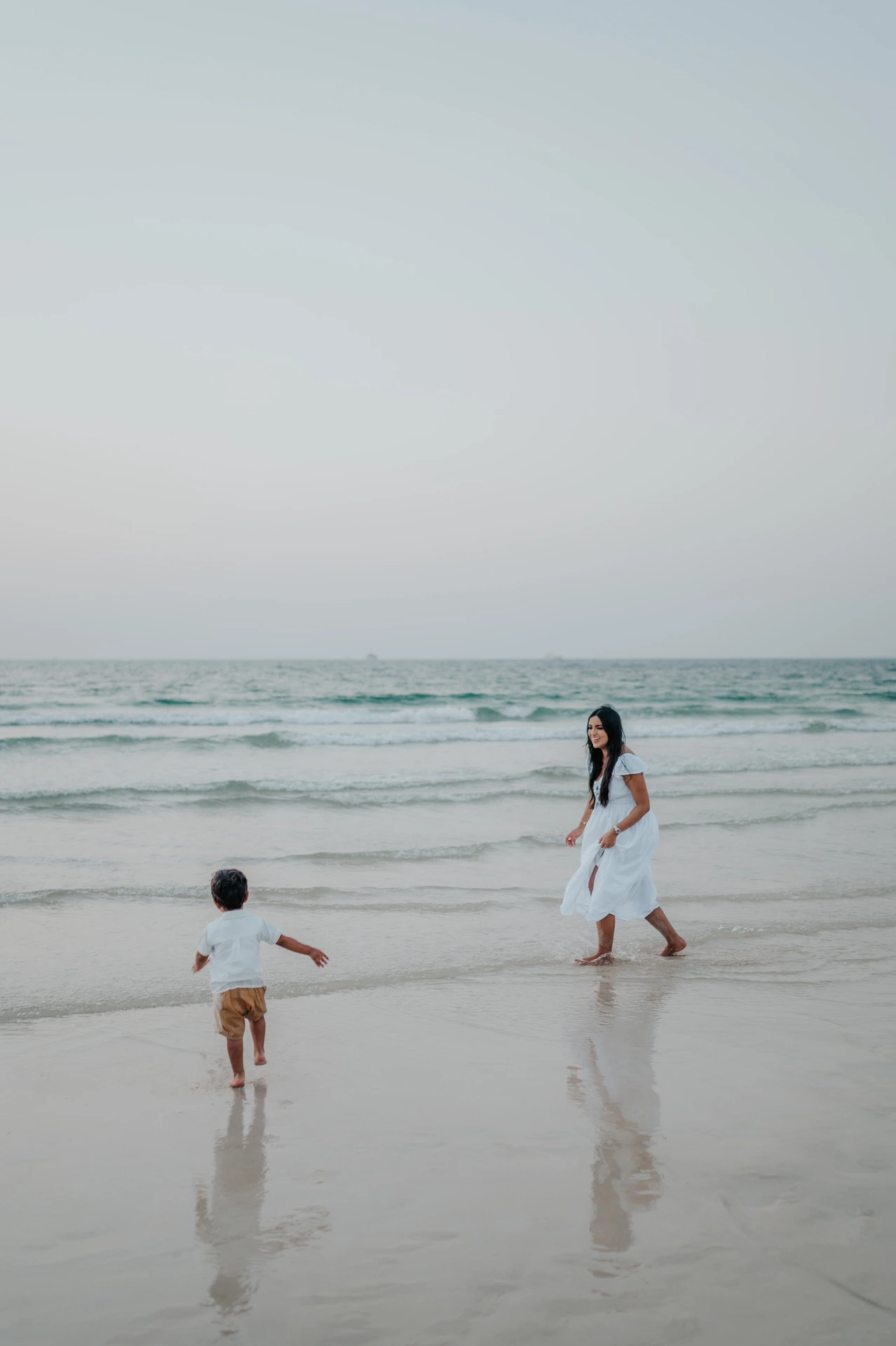 Mother and child playing on the beach in Dubai