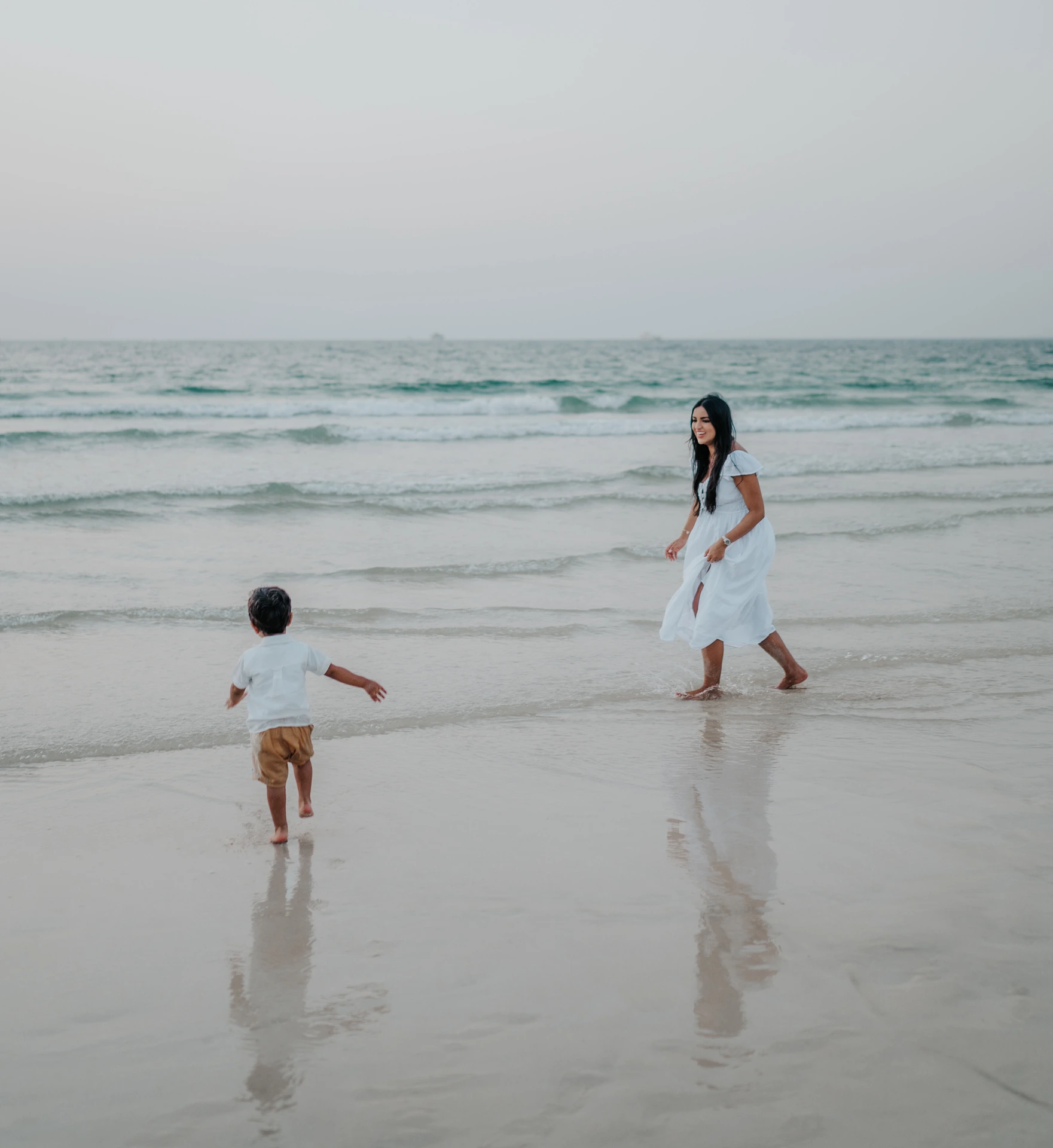 Family photoshoot on Dubai beach with parent and child