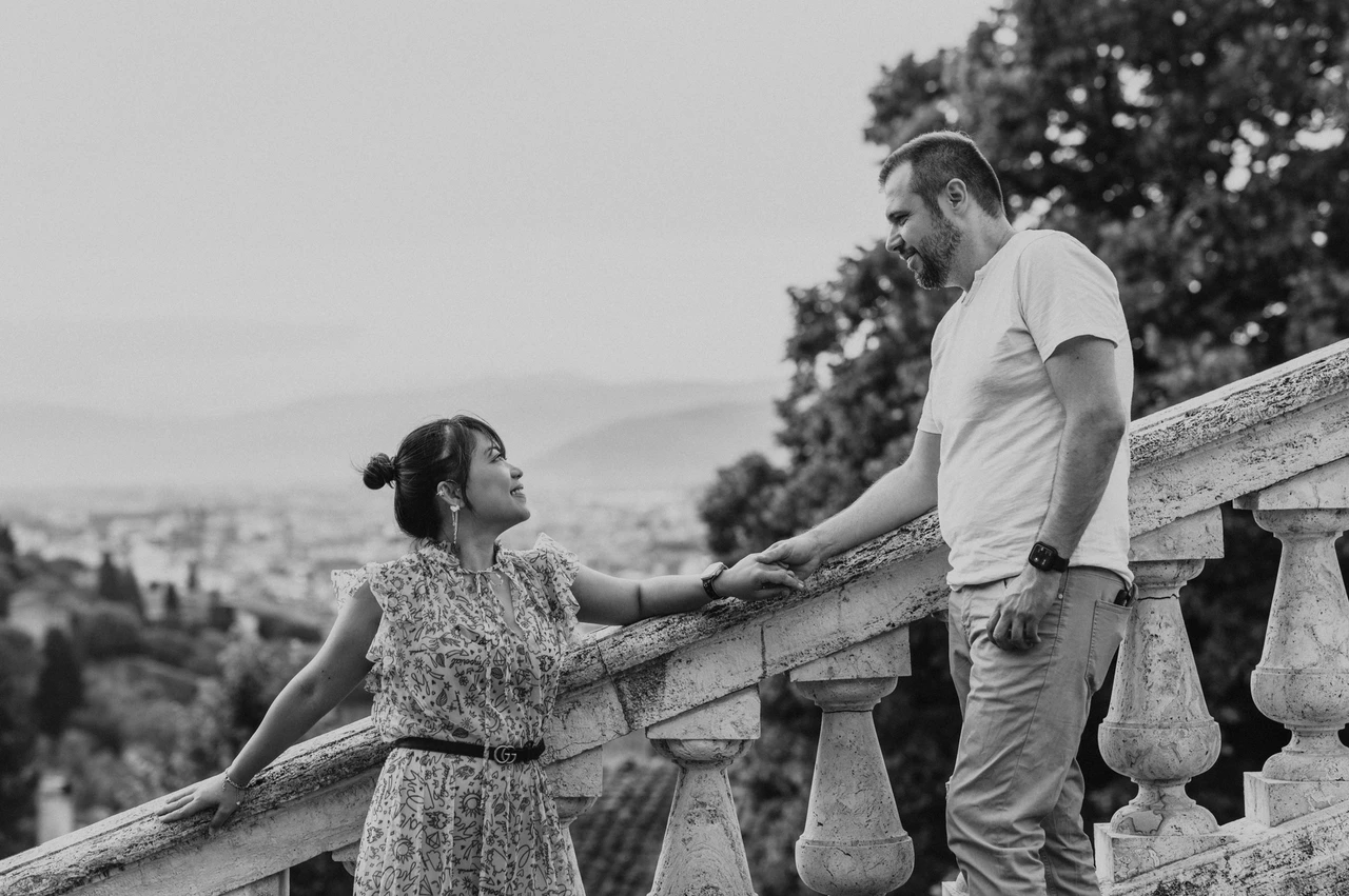 Black-and-white Florence photoshoot on the stone staircase Black-and-white Florence photoshoot of the couple holding hands on the stone staircase, framed by the sloping balustrade and trees.