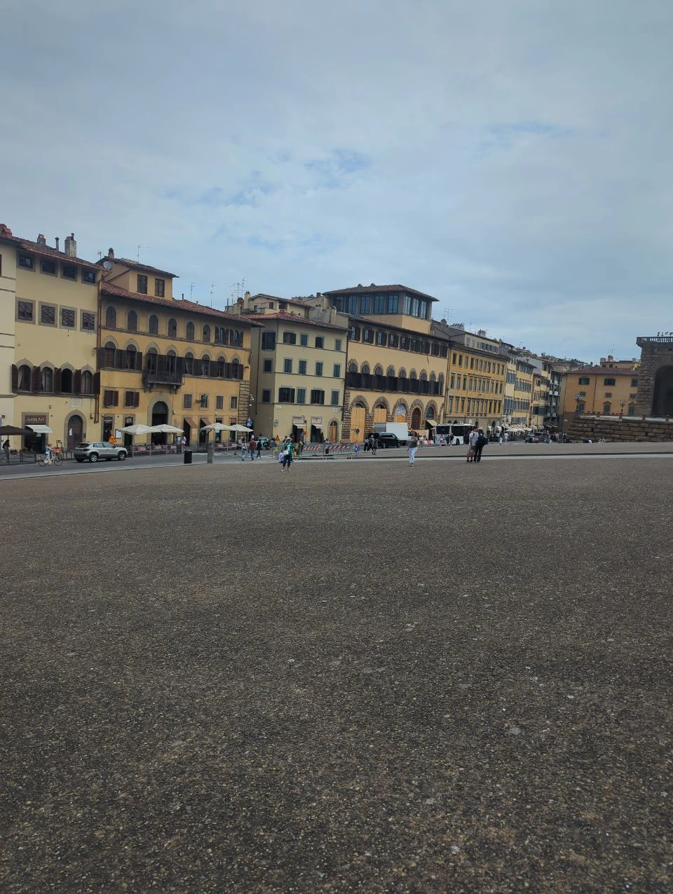 Florence Instagram Spots - Oltrarno Historic Square A broad paved square beside ochre historic buildings introduces the architectural atmosphere around Florence's Oltrarno and Palazzo Pitti area.