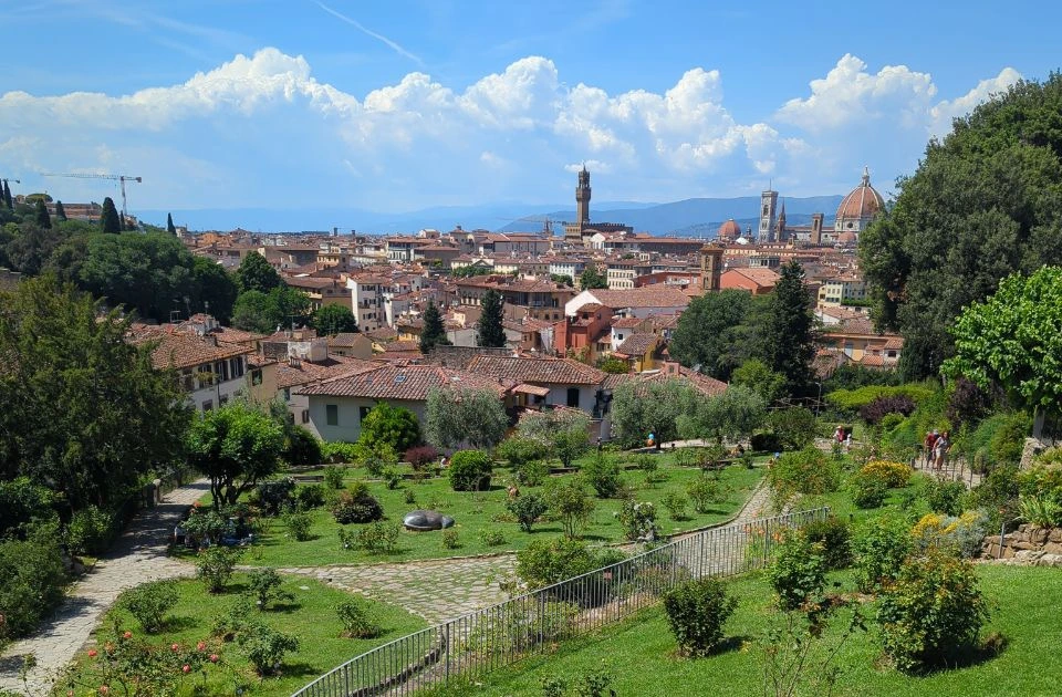 Rose Garden paths and lawns overlook Florence rooftops, Palazzo Vecchio and the Duomo in a bright daytime setting for a photoshoot.