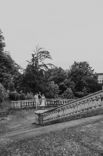 Florence proposal photoshoot among stone stairs in black and white Black-and-white view of the couple among the stone stairs, balustrades and trees during their Florence proposal photoshoot.