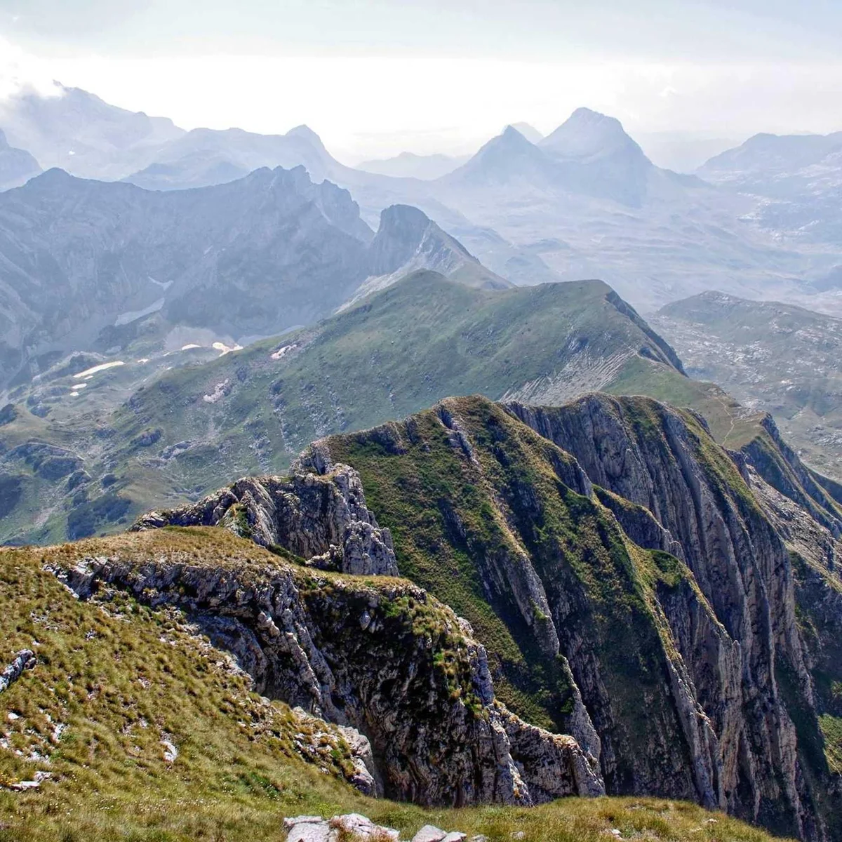 Layered mountain ridges receding into misty distance showing dramatic terrain