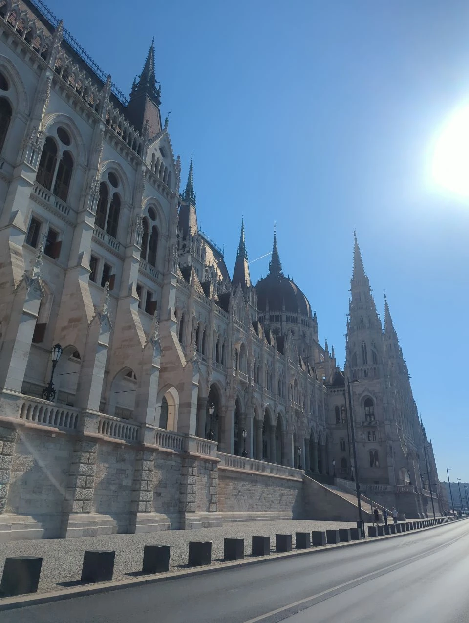 Angled view of the Hungarian Parliament facade and dome from beside the building