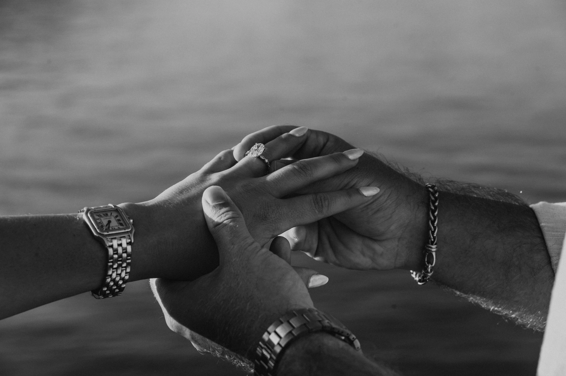 Black-and-white close-up of the couple’s joined hands and her engagement ring during their Lake Como photoshoot in Menaggio.