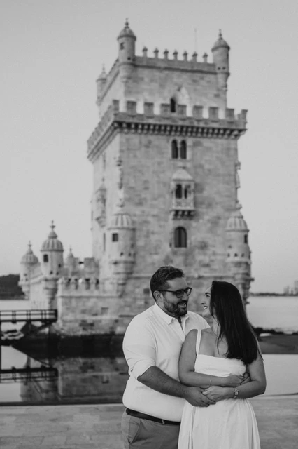 A close embrace in black and white | Lisbon anniversary photoshoot A black-and-white close portrait of the couple holding each other in front of Belém Tower during their anniversary photoshoot in Lisbon.