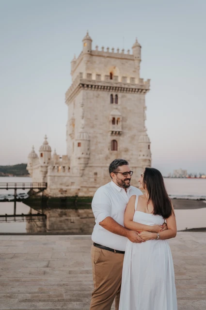 Looking at each other in an embrace | Lisbon anniversary photoshoot A closer portrait of the couple holding each other and looking at one another by Belém Tower during their anniversary photoshoot in Lisbon.