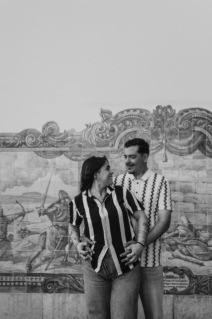 A close portrait of the parents together in black and white | Lisbon family photoshoot Black-and-white photograph: the parents smiling at each other in a close embrace against the blue tile panel during their family photoshoot in Lisbon.