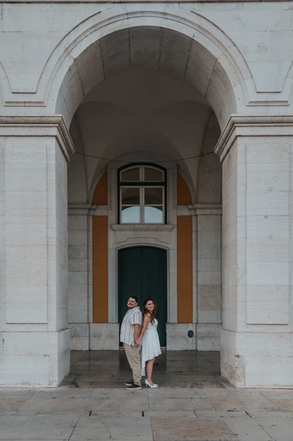 Looking up beneath the stone arch | Lisbon couple photoshoot The couple standing together and looking upwards beneath the stone arch during their couple photoshoot in Lisbon.