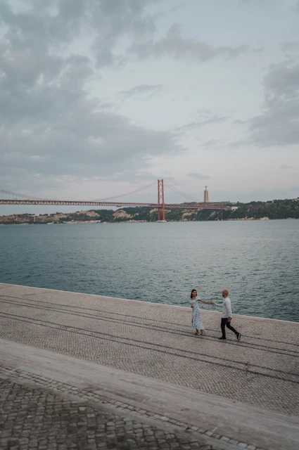 A waterfront turn from above | Lisbon couple photoshoot The couple turning towards each other on the waterfront, photographed from above during their couple photoshoot in Lisbon.