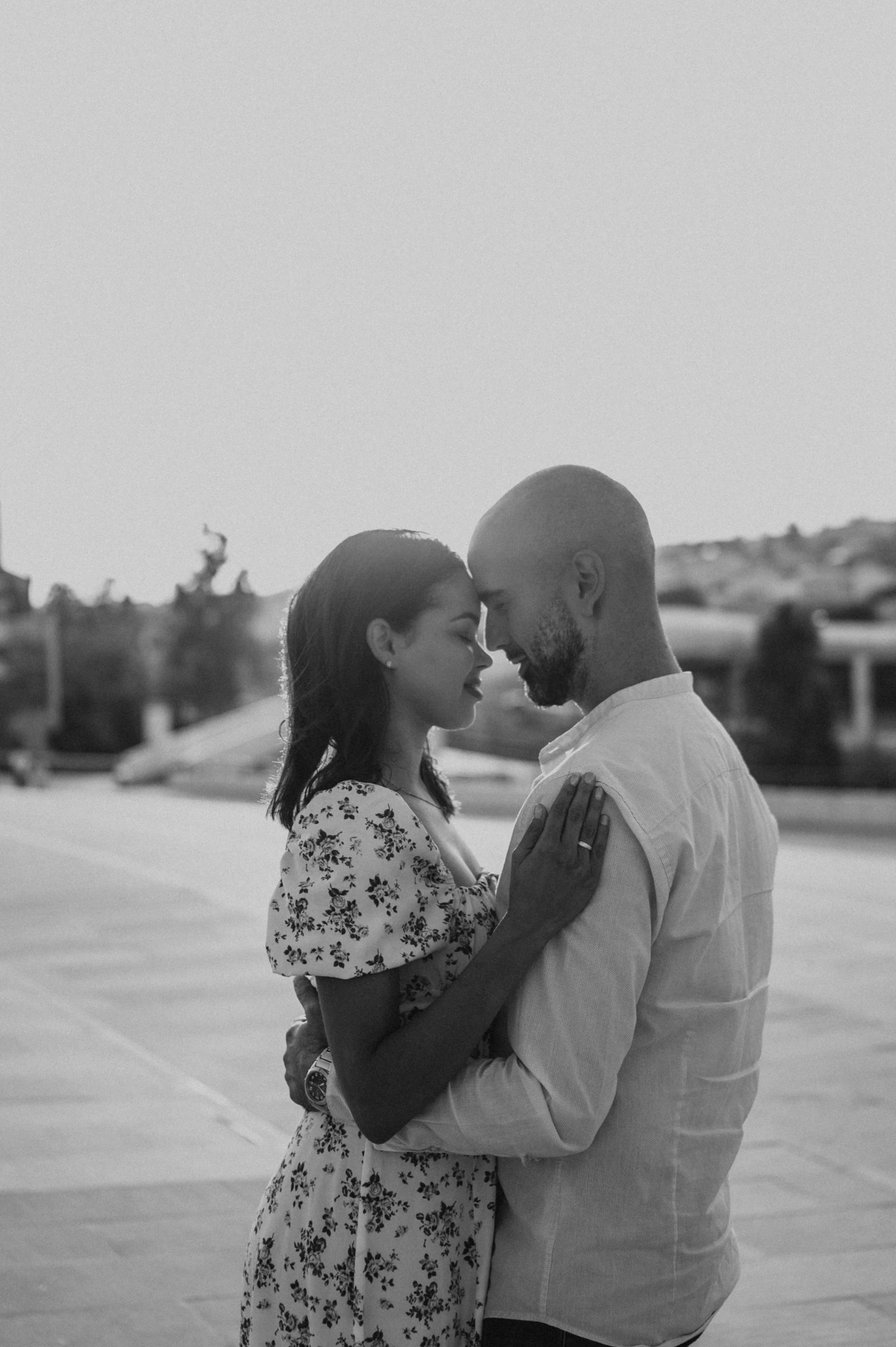A black-and-white portrait of the couple leaning their foreheads together near the MAAT during their couple photoshoot in Lisbon.