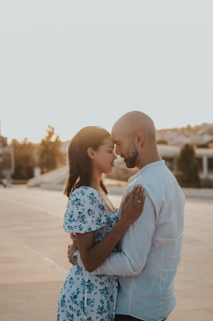 Foreheads together beside the MAAT | Lisbon couple photoshoot The couple leaning their foreheads together on the MAAT plaza during their couple photoshoot in Lisbon.