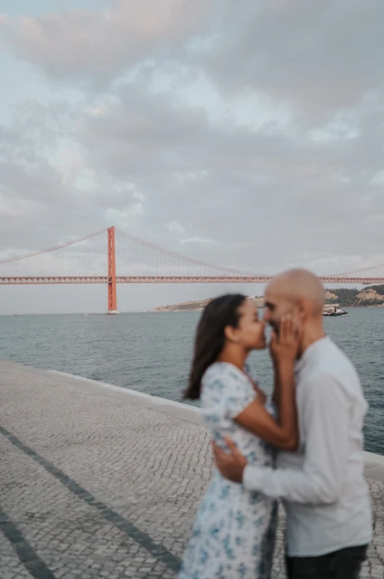 A close kiss in soft focus | Lisbon couple photoshoot A softly focused close portrait of the couple kissing beside the river during their couple photoshoot in Lisbon.