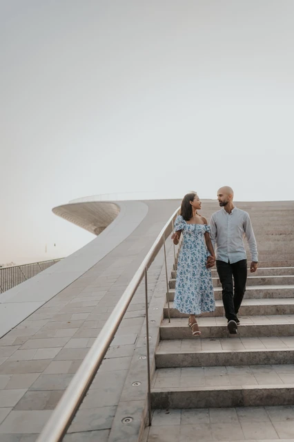 A shared glance on the staircase | Lisbon couple photoshoot The couple sharing a glance while descending the MAAT steps during their couple photoshoot in Lisbon.