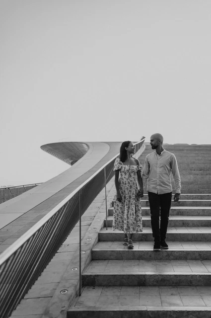 The MAAT staircase in black and white | Lisbon couple photoshoot A black-and-white photograph of the couple walking down the MAAT staircase during their couple photoshoot in Lisbon.