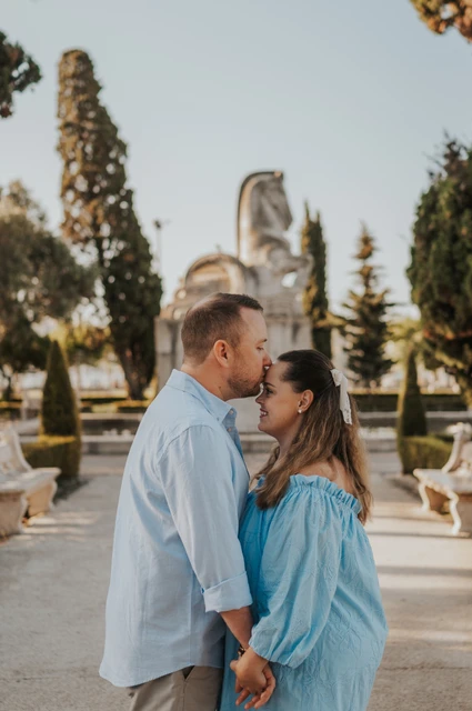 A close portrait among the garden trees | Lisbon engagement photoshoot The couple leaning towards each other for a close portrait in the garden during their engagement photoshoot in Lisbon.