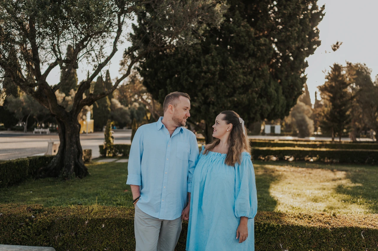 Side by side in the gardens | Lisbon engagement photoshoot The couple smiling at each other in the gardens near Jerónimos Monastery during their engagement photoshoot in Lisbon.