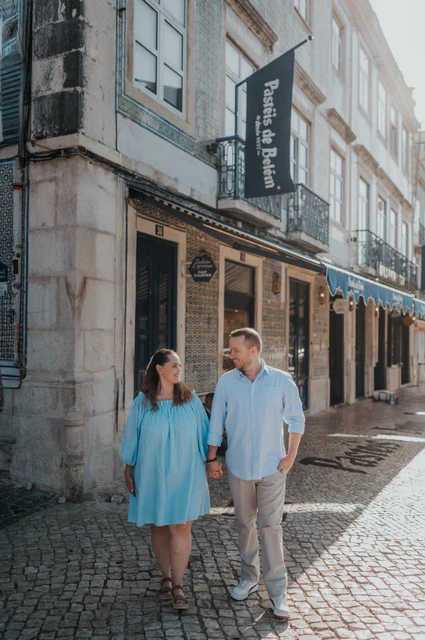 A walk outside Pastéis de Belém | Lisbon engagement photoshoot The couple walking hand in hand outside Pastéis de Belém during their engagement photoshoot in Lisbon.