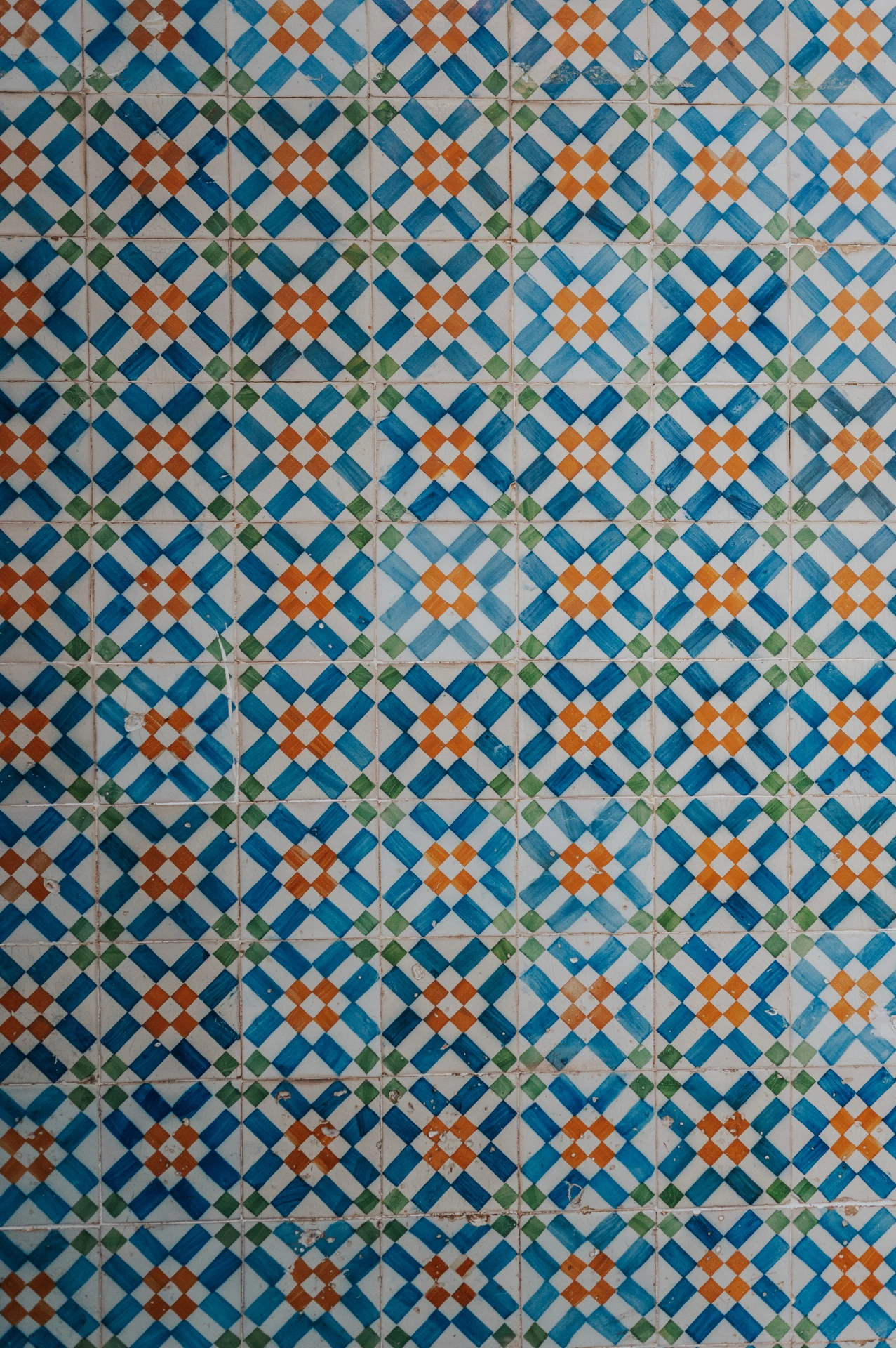 A close view of the blue, white and yellow patterned tile wall during their engagement photoshoot in Lisbon.