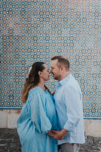 A kiss beside the patterned tiles | Lisbon engagement photoshoot The couple leaning together for a kiss in front of the patterned tile wall during their engagement photoshoot in Lisbon.