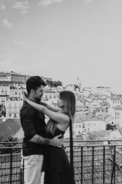 A soft embrace in black and white | Lisbon engagement photoshoot A softly focused black-and-white portrait of the couple embracing at Portas do Sol during their engagement photoshoot in Lisbon.
