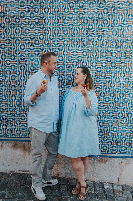 Couple beside a blue azulejo wall in Lisbon