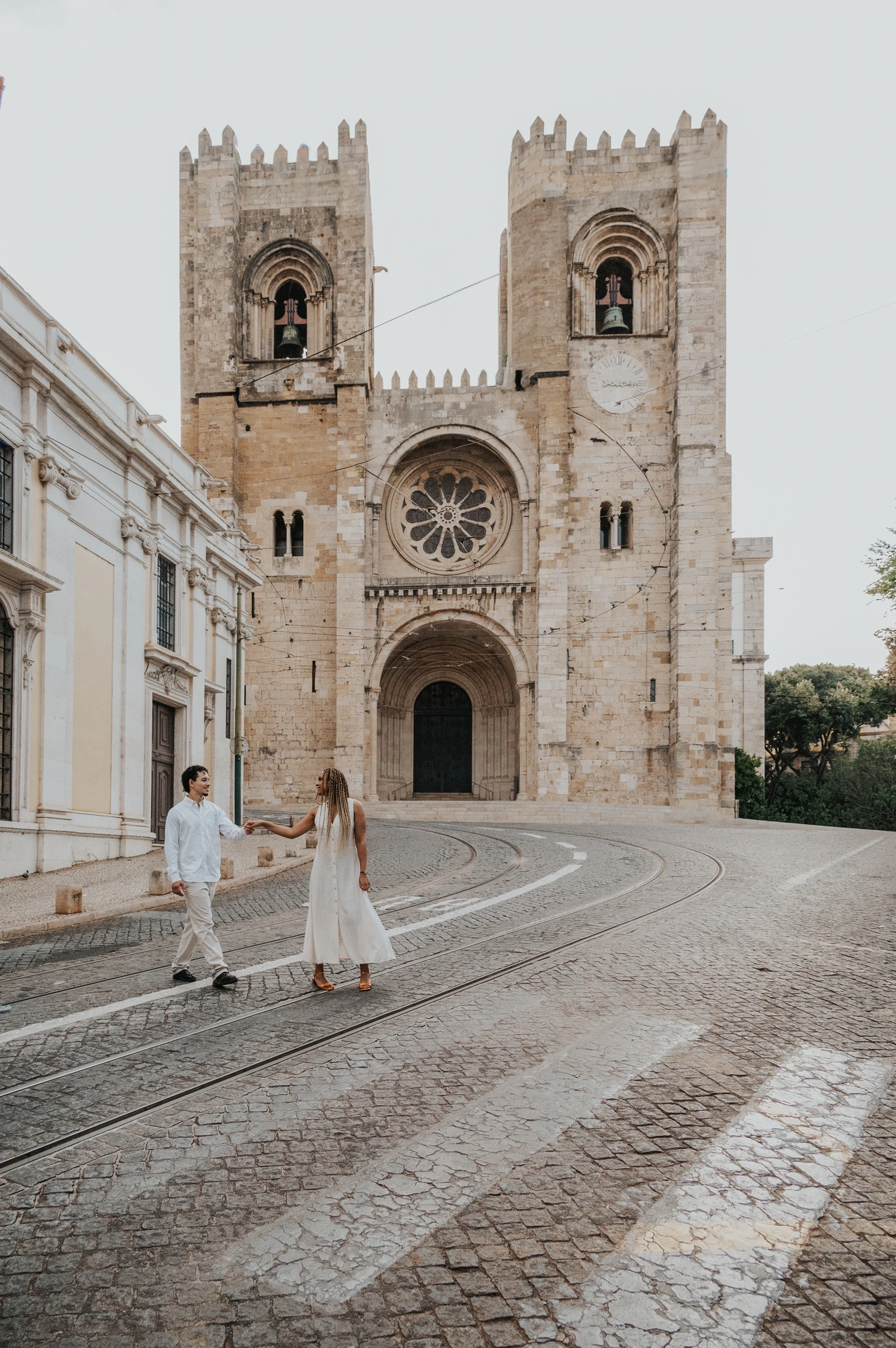 The couple together on the cobbled street in front of Lisbon’s cathedral during their couple photoshoot in Lisbon.