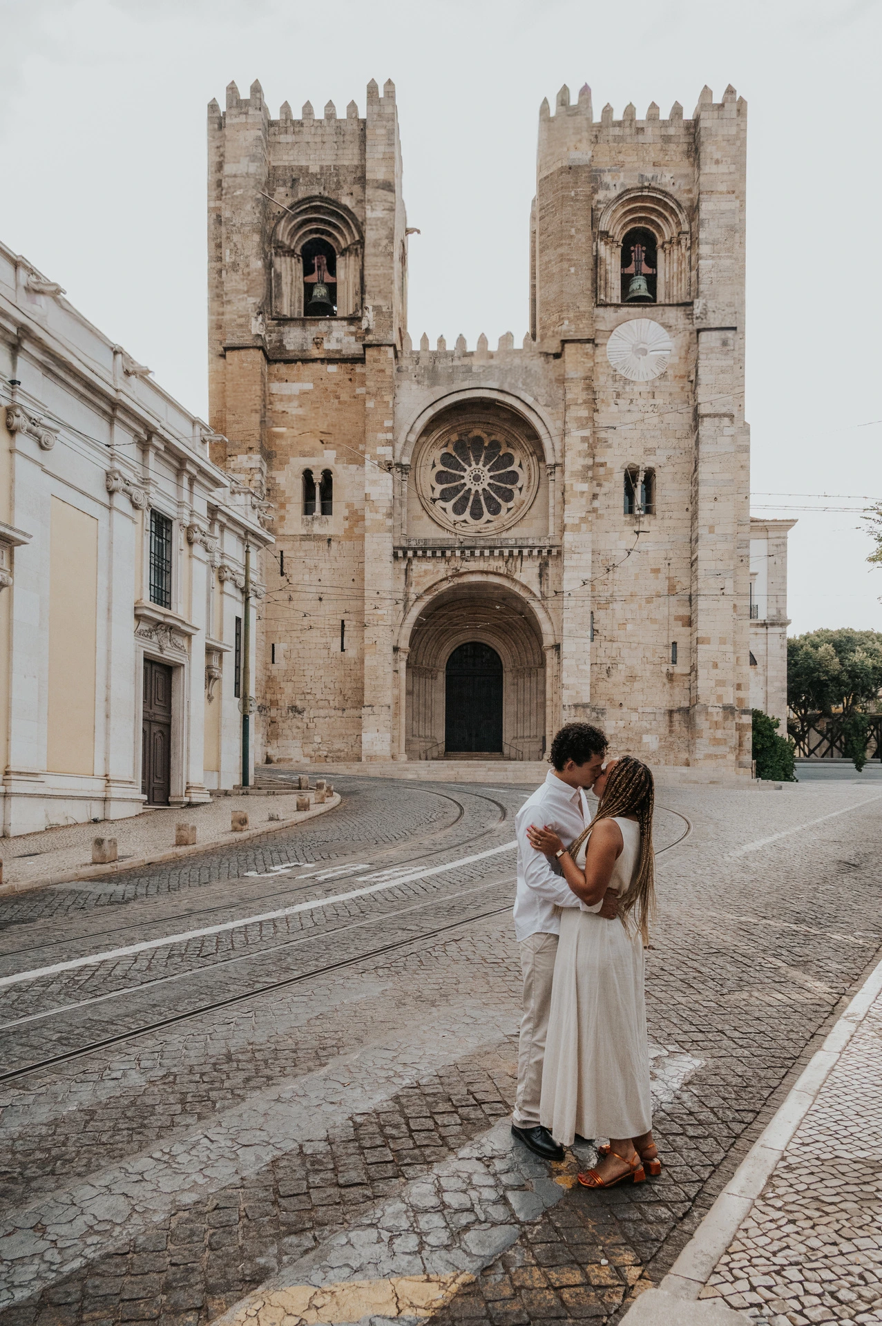 The couple together on the cobbled street in front of Lisbon’s cathedral during their couple photoshoot in Lisbon.